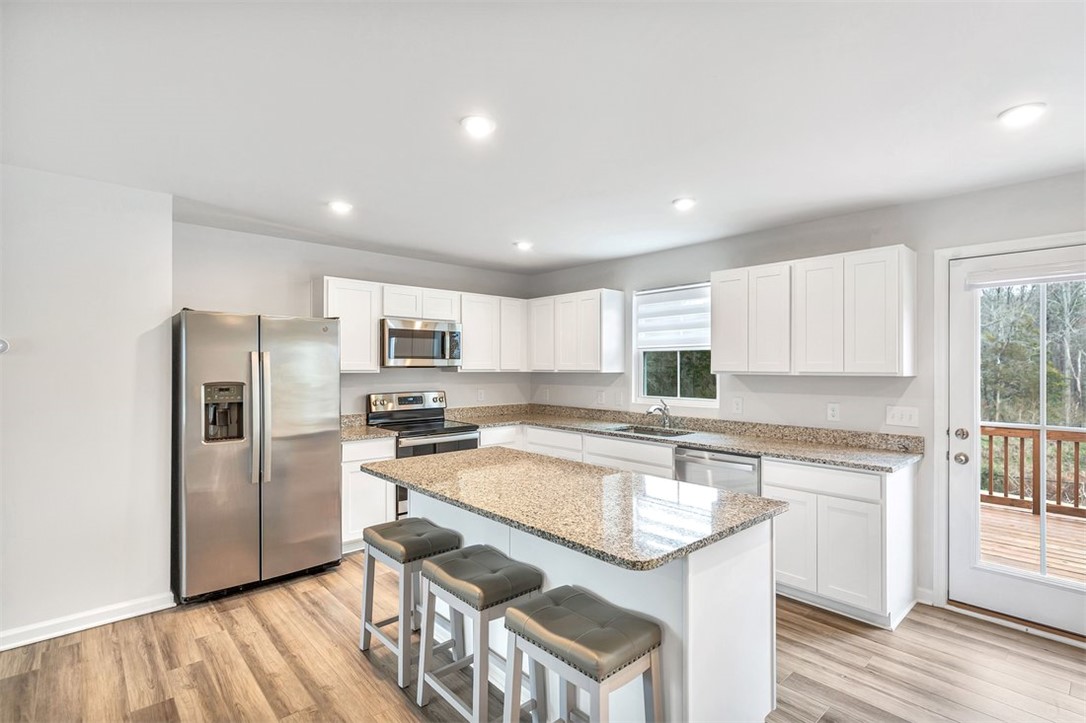 150 Queens Mill Court Pendleton, SC 29670 - Photo 6 of 37 This kitchen features a bright layout, ample counter space, and direct access to outdoor living.