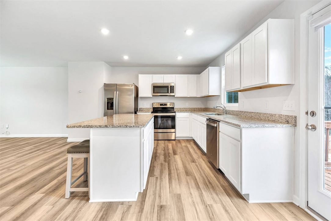 150 Queens Mill Court Pendleton, SC 29670 - Photo 7 of 37 This bright kitchen features durable flooring and contemporary appliances, perfect for everyday living and entertaining.