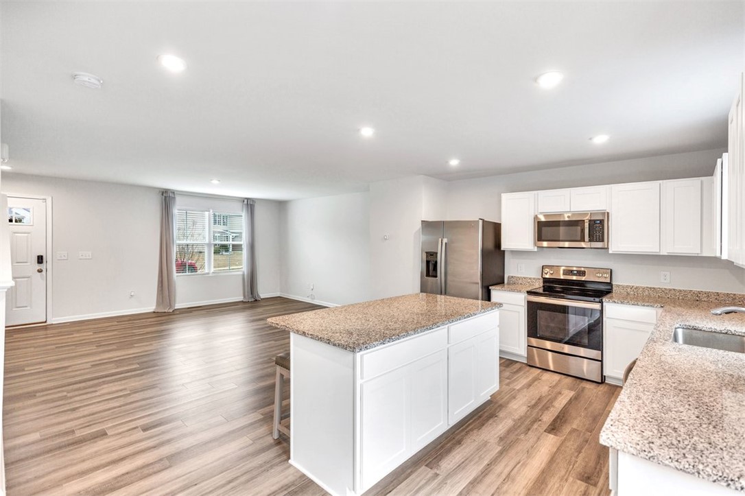150 Queens Mill Court Pendleton, SC 29670 - Photo 8 of 37 This open concept space features a kitchen island and modern appliances, perfect for entertaining.