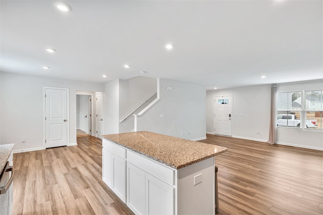 150 Queens Mill Court Pendleton, SC 29670 - Photo 9 of 37 This bright, open-concept living space boasts a kitchen island, creating a seamless flow for everyday living.