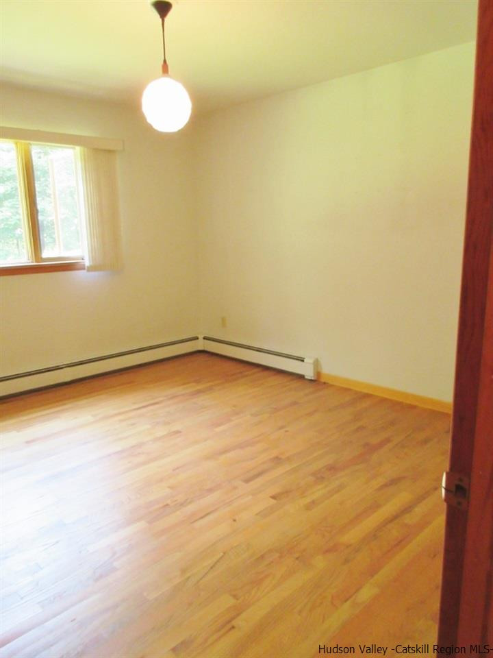 48 Saxton Flats Road Saugerties, NY 12477 - Photo 13 of 21 a view of empty room with wooden floor and fan