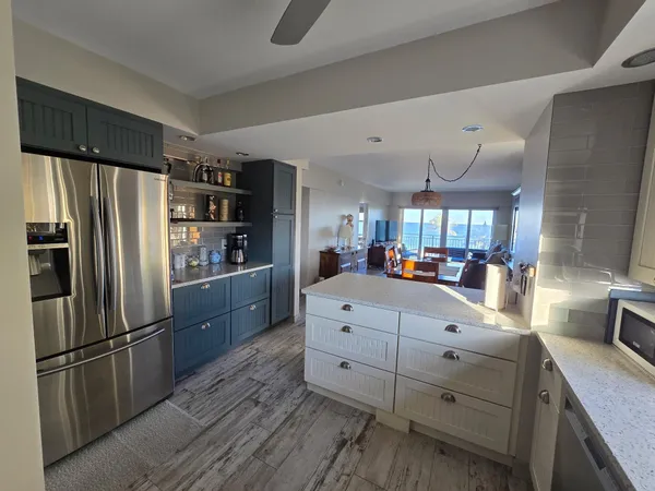 a kitchen with granite countertop a refrigerator and a sink