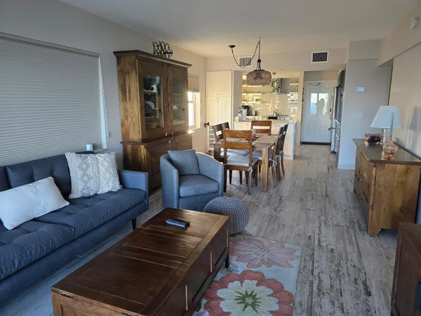 a living room with furniture and a dining table