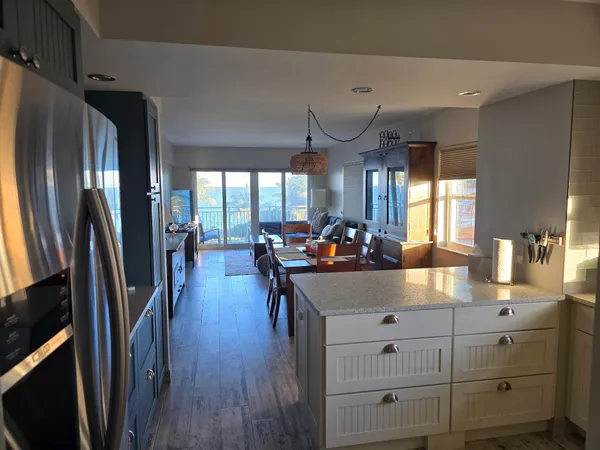 a kitchen with sink refrigerator and window