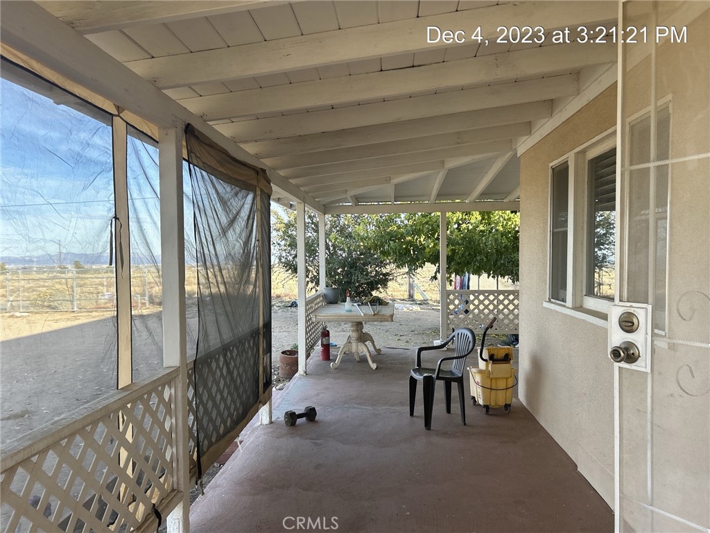 9548 White Road Phelan, CA 92371 - Photo 2 of 8 a view of a patio with table and chairs and floor to ceiling window