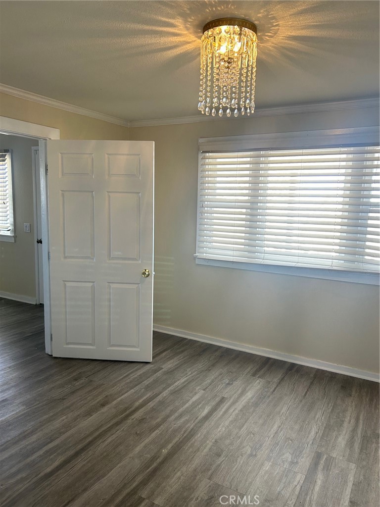9548 White Road Phelan, CA 92371 - Photo 8 of 8 a view of an empty room with wooden floor and a window