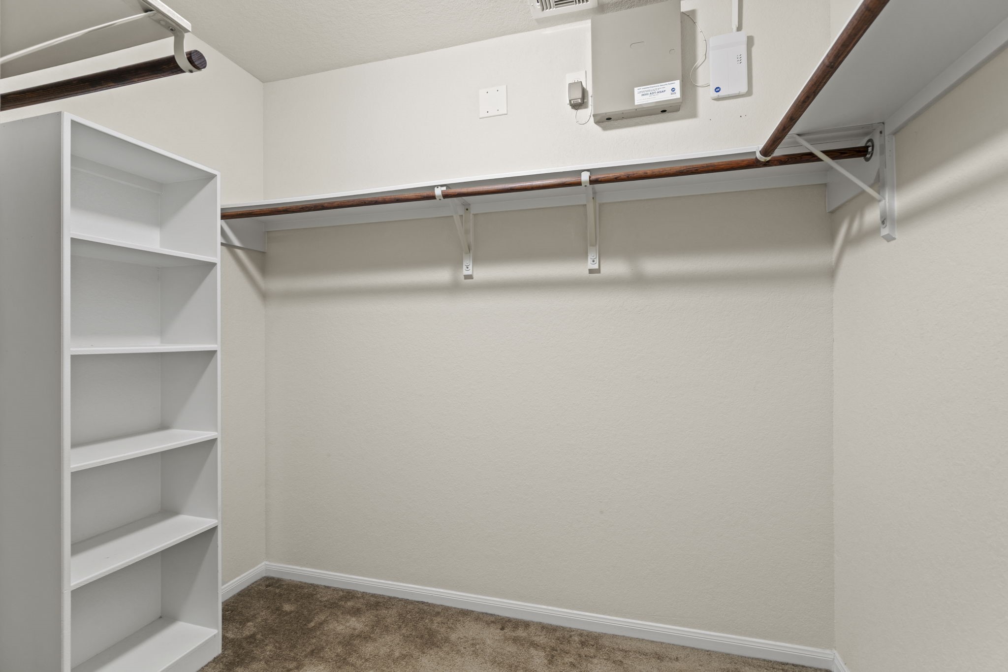 2110 Red Cedar Trail Rosenberg, TX 77471 - Photo 11 of 20 A deep walk-in closet featuring extensive built-in storage solutions. Completely carpeted and move-in ready, it offers great functional utility right off the primary suite.