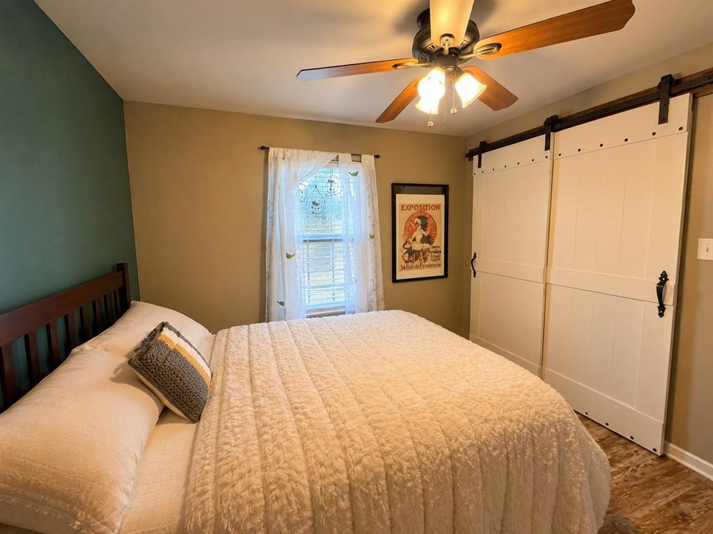 420 Sessums Road Springtown, TX 76082 - Photo 27 of 40 Wood-finish flooring complemented by a rich green accent wall-virtually staged