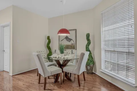 a view of a dining room with furniture and wooden floor