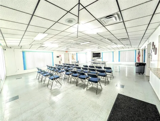 a kitchen with stainless steel appliances kitchen island granite countertop a stove and white cabinets