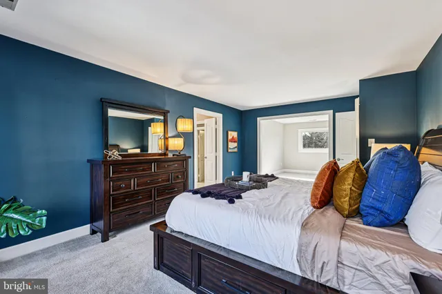 an empty room with windows and entrance to other room