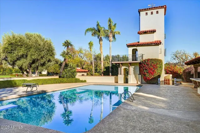 a view of a swimming pool with an outdoor seating and a yard
