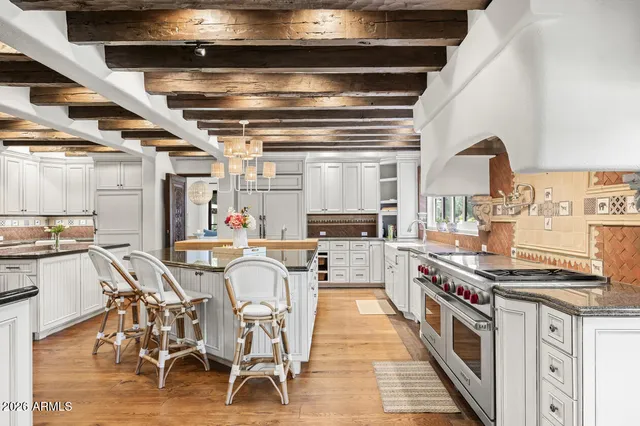 a kitchen with stainless steel appliances granite countertop a stove and cabinets
