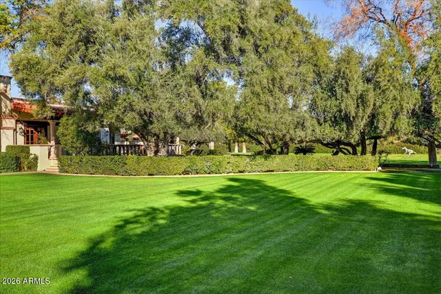 a view of a house with a yard and sitting area