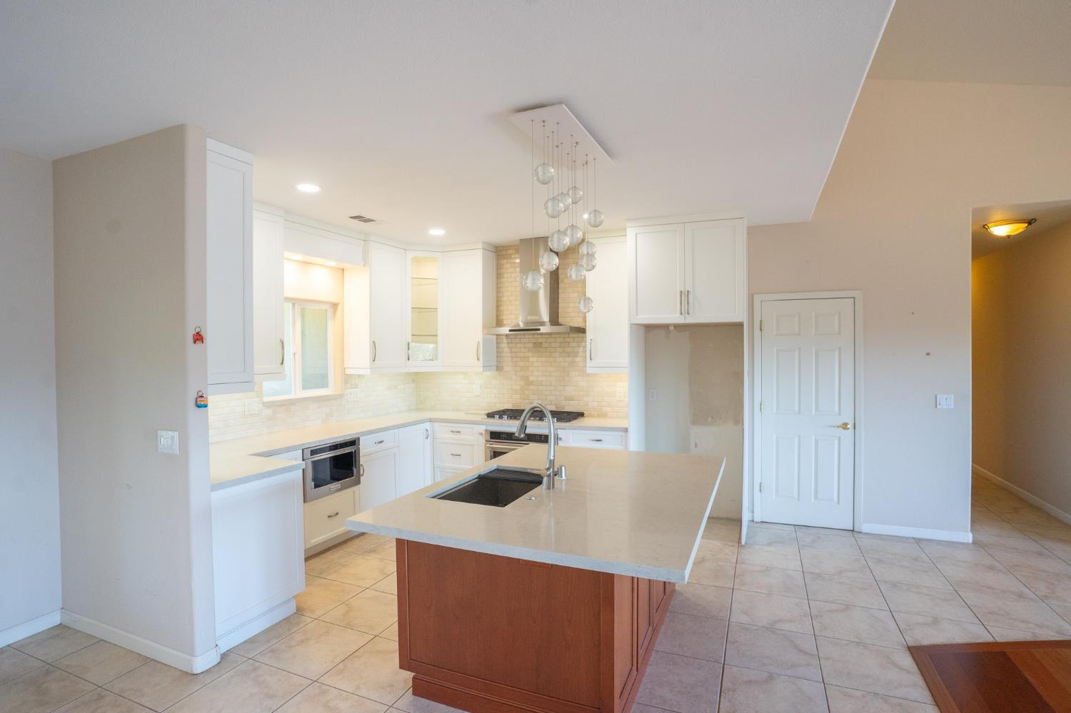3235 Hagen Road Valley Springs, CA 95252 - Photo 11 of 56 a kitchen with stainless steel appliances a sink a stove a refrigerator and cabinets