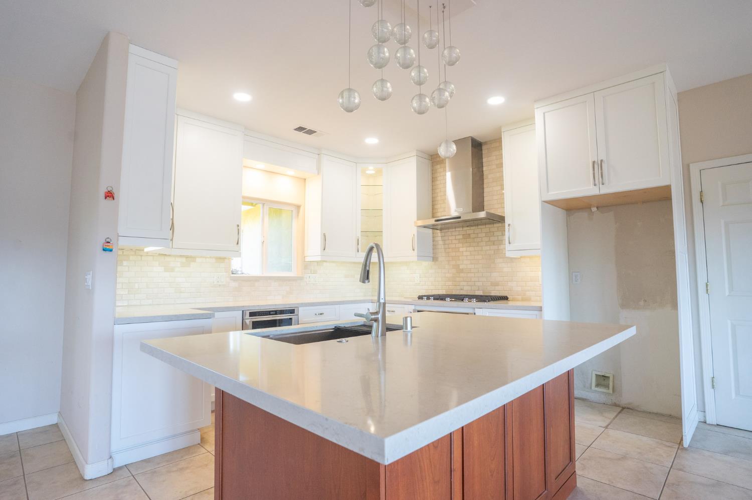 3235 Hagen Road Valley Springs, CA 95252 - Photo 15 of 56 a kitchen with kitchen island granite countertop a sink and refrigerator