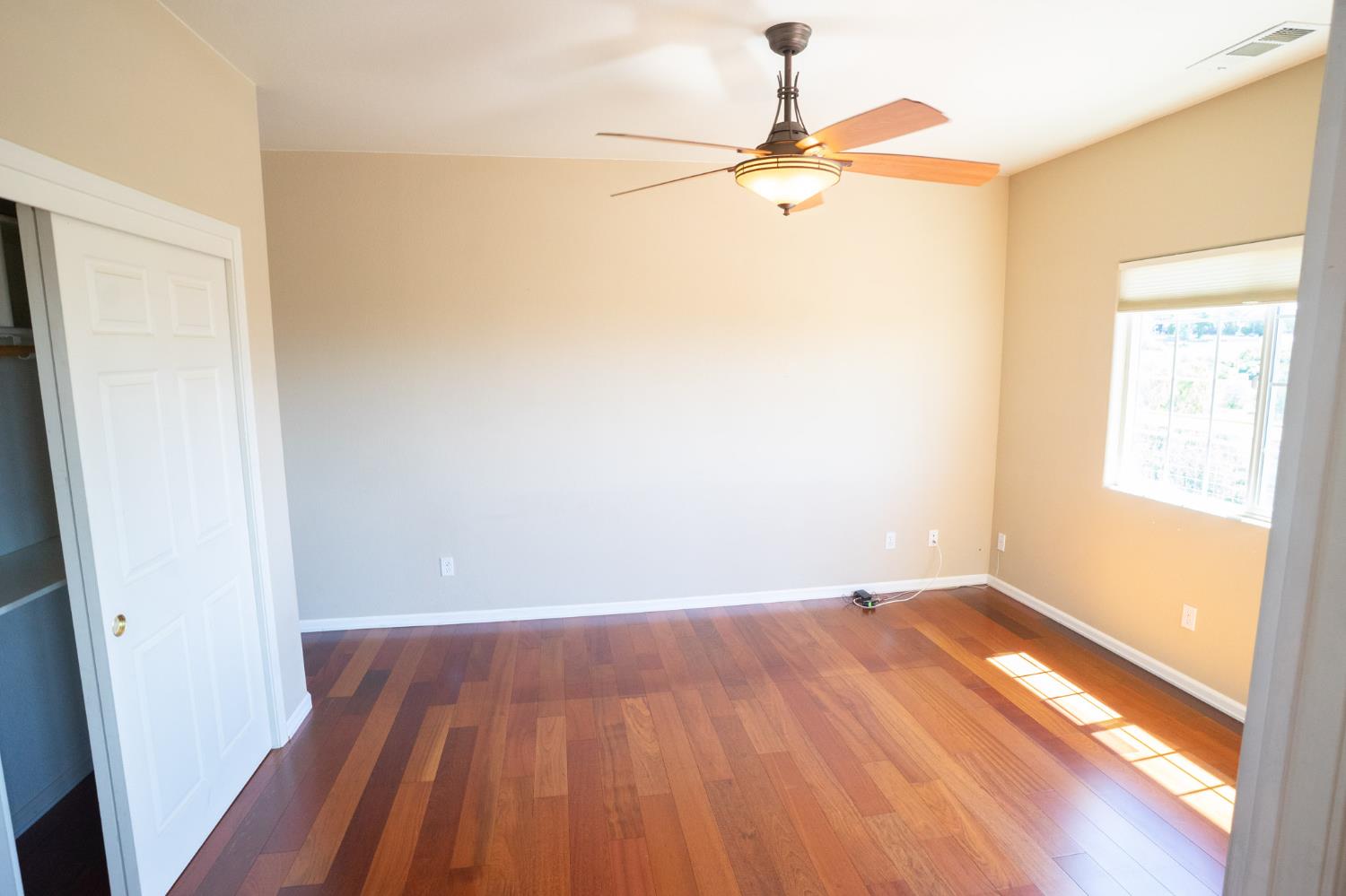 3235 Hagen Road Valley Springs, CA 95252 - Photo 19 of 56 a view of a room with wooden floor a ceiling fan and window