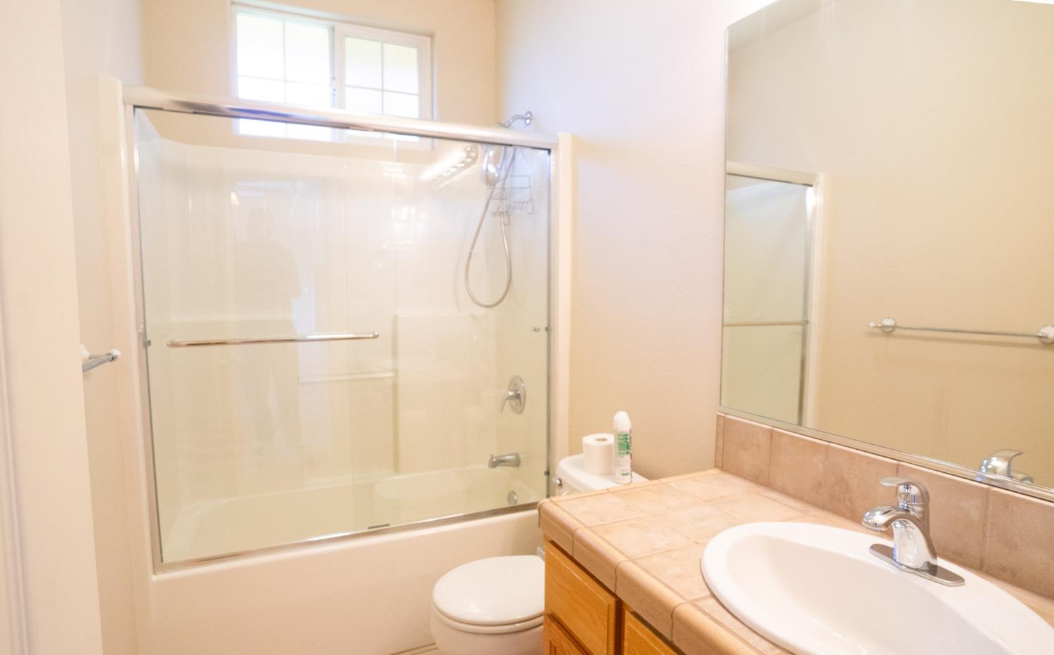 3235 Hagen Road Valley Springs, CA 95252 - Photo 22 of 56 a bathroom with a granite countertop sink toilet and shower
