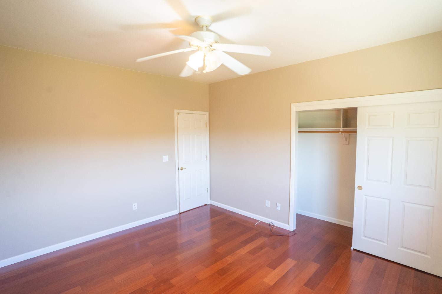 3235 Hagen Road Valley Springs, CA 95252 - Photo 23 of 56 an empty room with wooden floor and fan