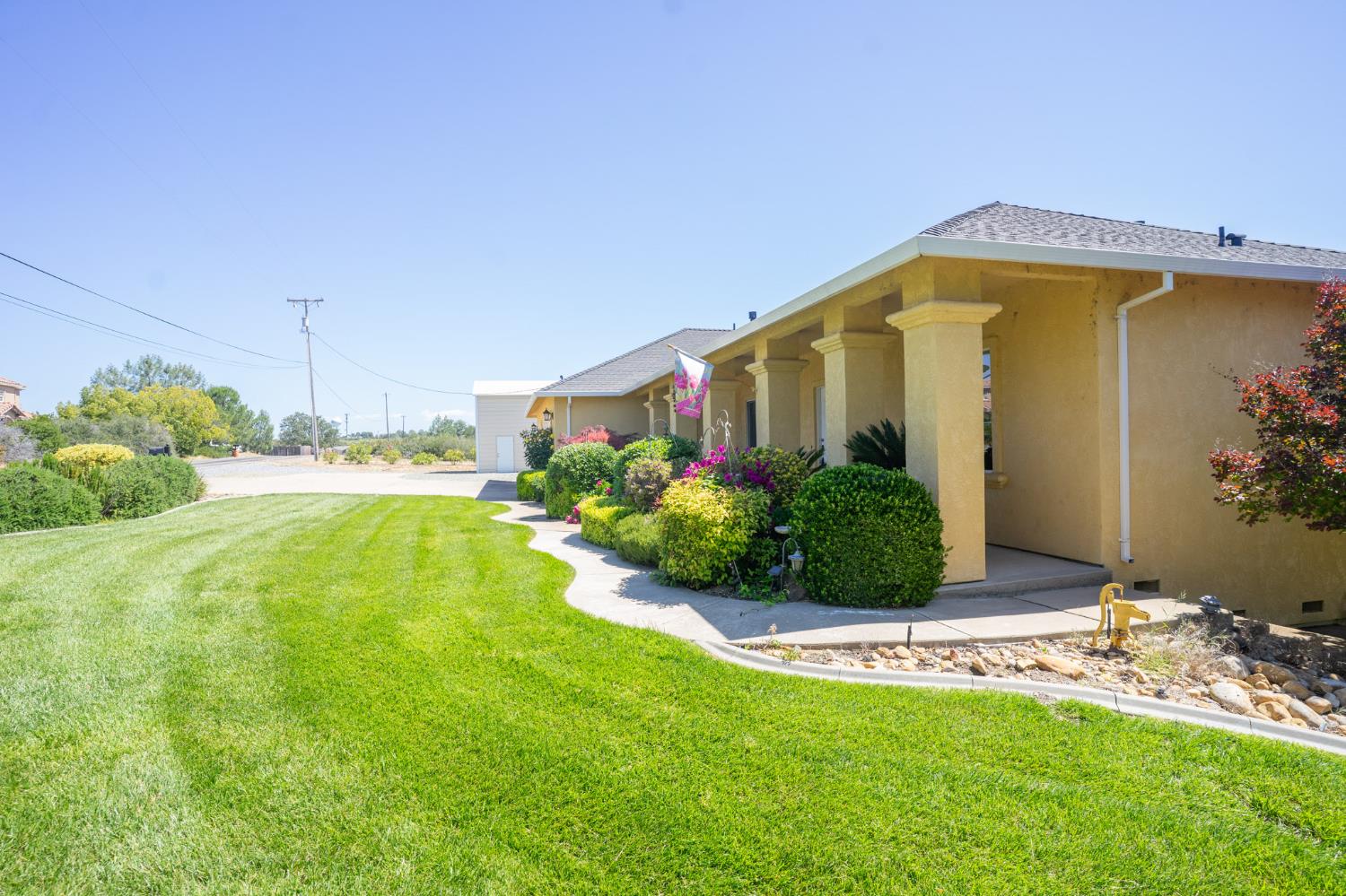 3235 Hagen Road Valley Springs, CA 95252 - Photo 38 of 56 a front view of yellow house with a yard