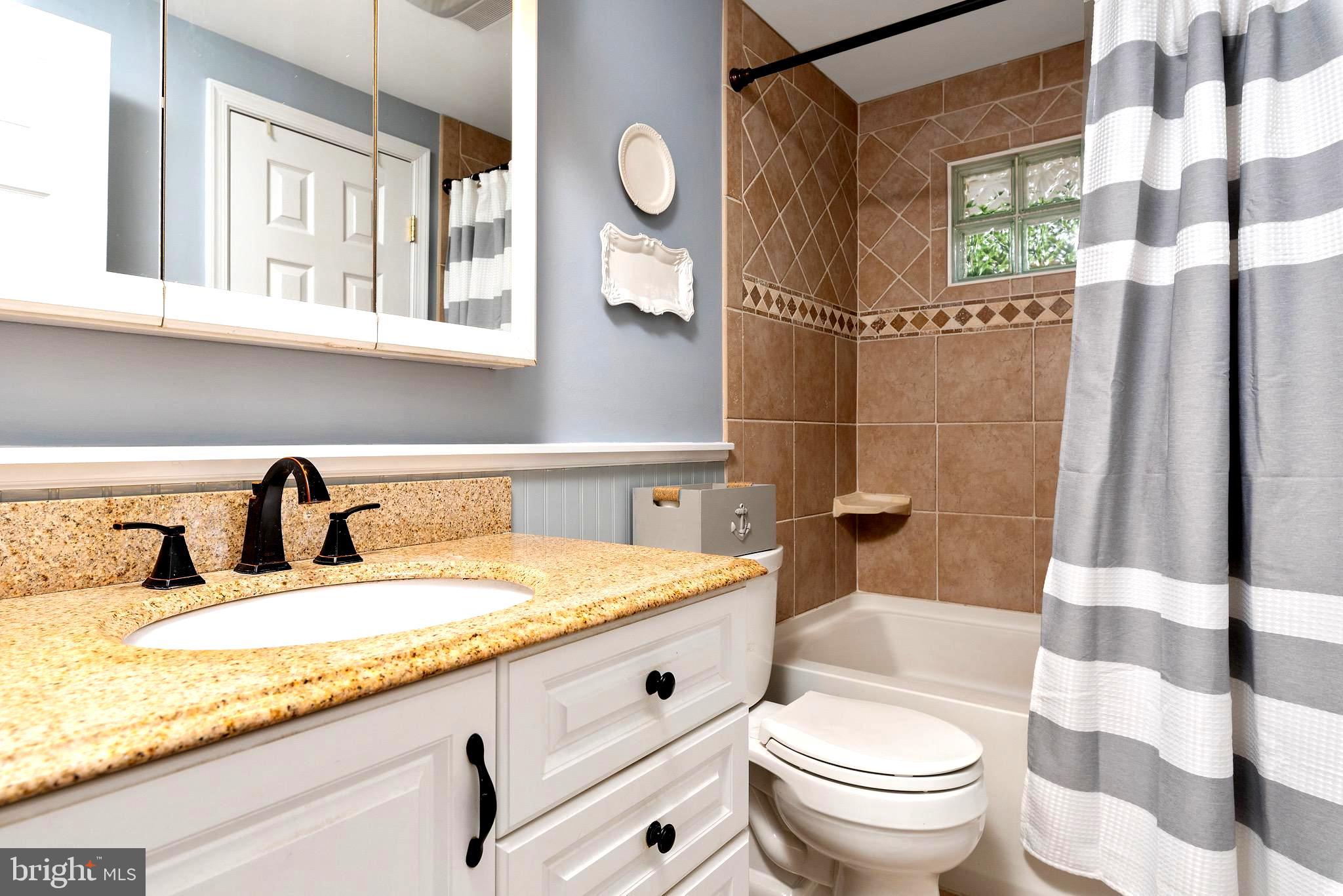 719 Pin Oak Road Severna Park, MD 21146 - Photo 25 of 39 Remodeled Hall Bath with Tuscan Tile Tub/Shower