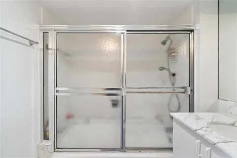a bathroom with a glass shower door