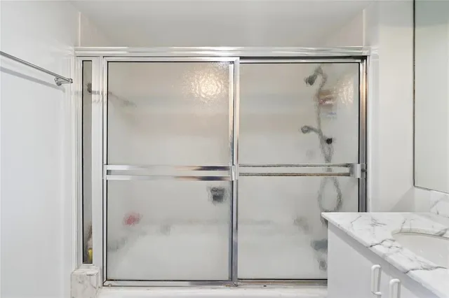 a bathroom with a glass shower door