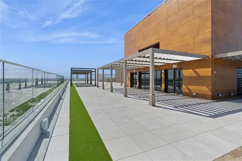 a view of a patio with chairs and umbrellas on a balcony