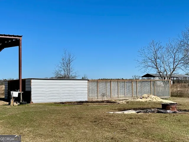 a view of a field with trees in the background