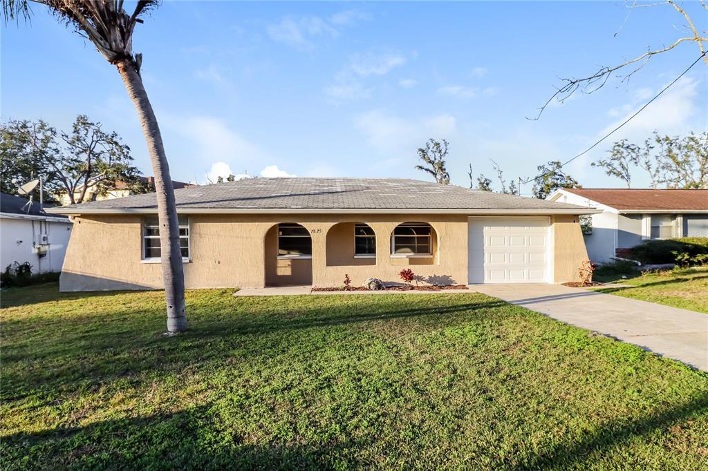 7825 Bolam Avenue New Port Richey, FL 34653 - Photo 1 of 1 a front view of a house with garden