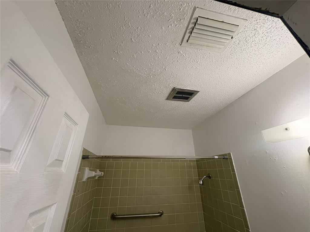 1829 South Center Street Denison, TX 75021 - Photo 17 of 29 a bathroom with a shower