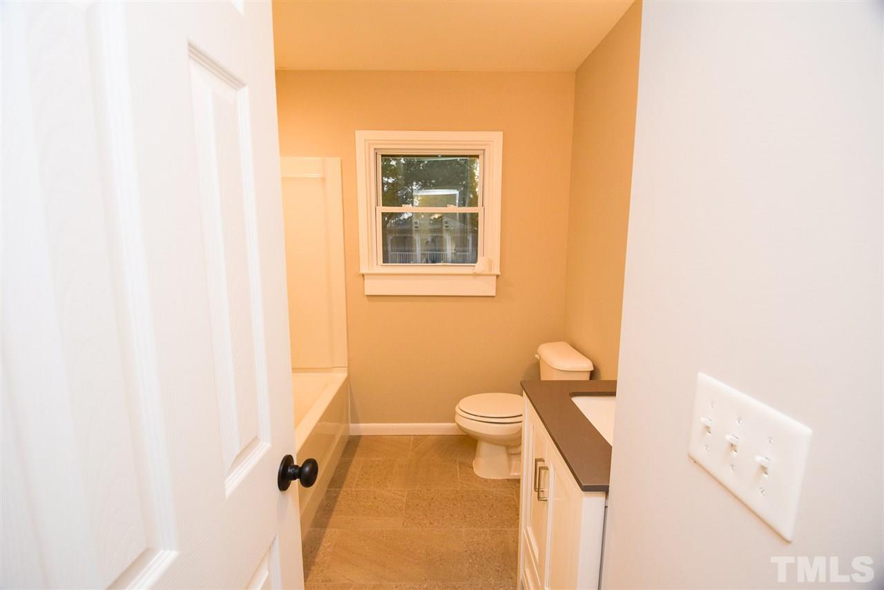 5300 Rock Quarry Road Raleigh, NC 27610 - Photo 11 of 19 a bathroom with a sink a toilet and a window
