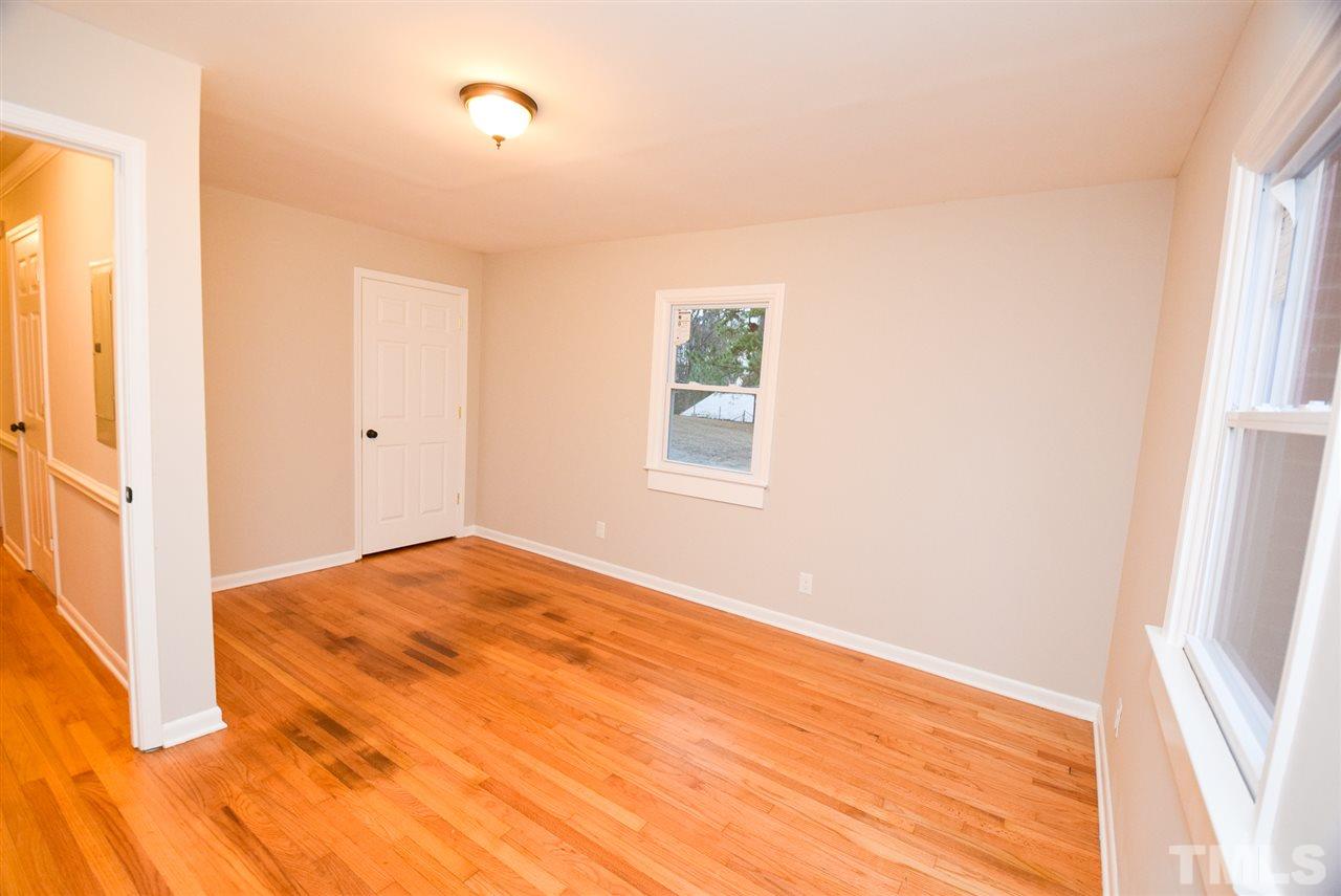 5300 Rock Quarry Road Raleigh, NC 27610 - Photo 13 of 19 a view of an empty room with wooden floor and a window