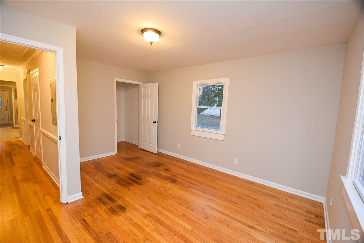 5300 Rock Quarry Road Raleigh, NC 27610 - Photo 14 of 19 a view of an empty room with wooden floor and a window