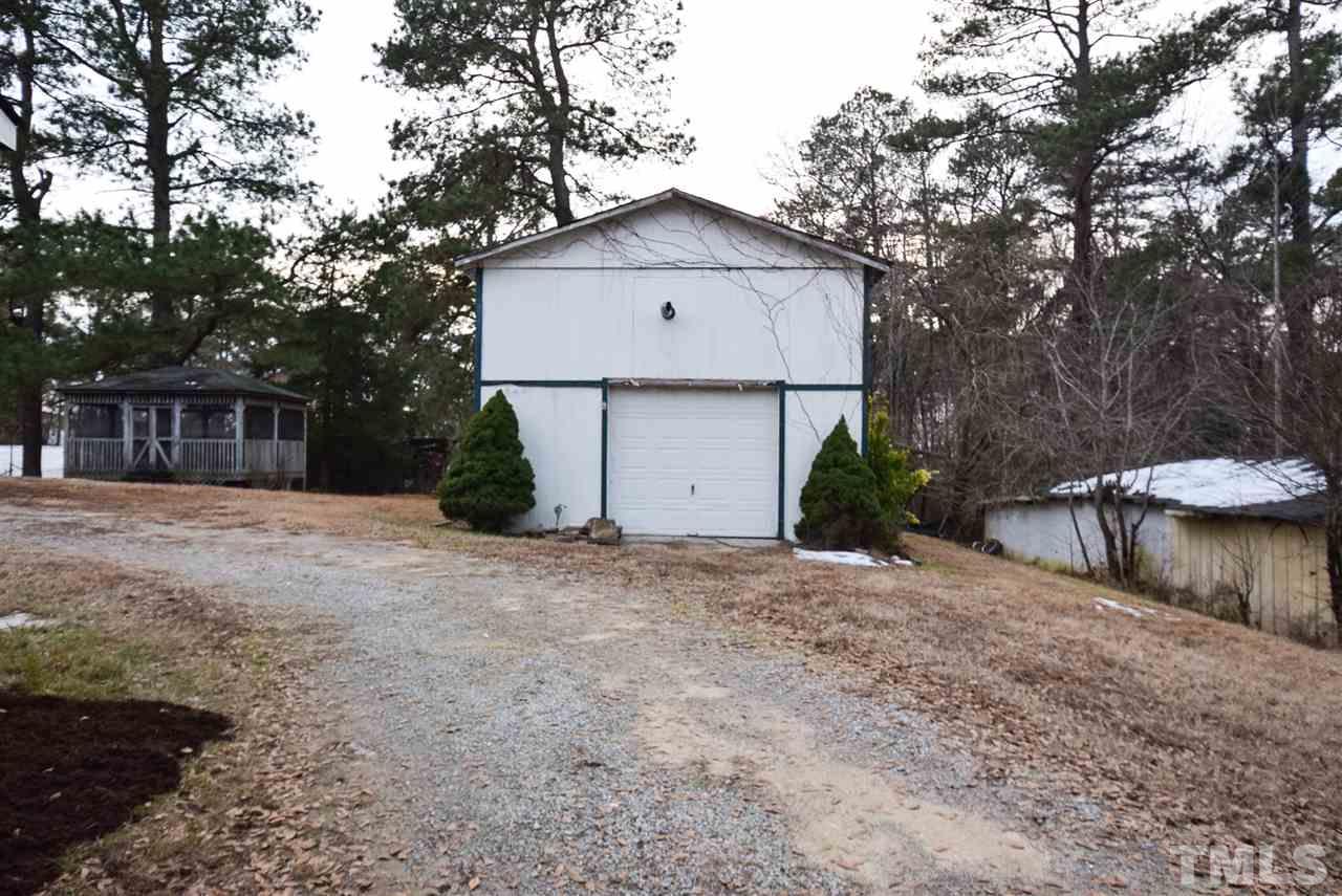 5300 Rock Quarry Road Raleigh, NC 27610 - Photo 15 of 19 a front view of a house with a yard and garage