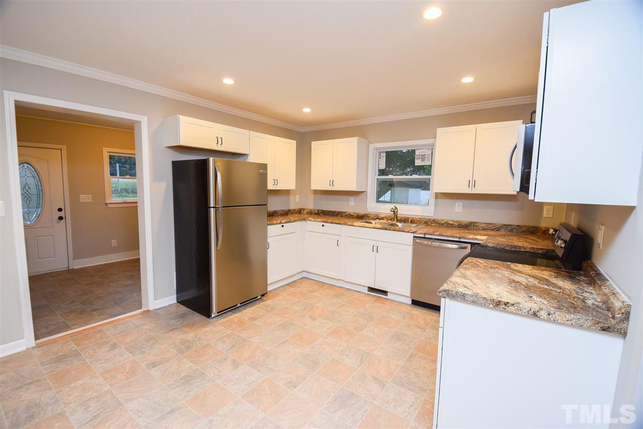 5300 Rock Quarry Road Raleigh, NC 27610 - Photo 7 of 19 a kitchen with stainless steel appliances granite countertop a refrigerator a stove and a sink