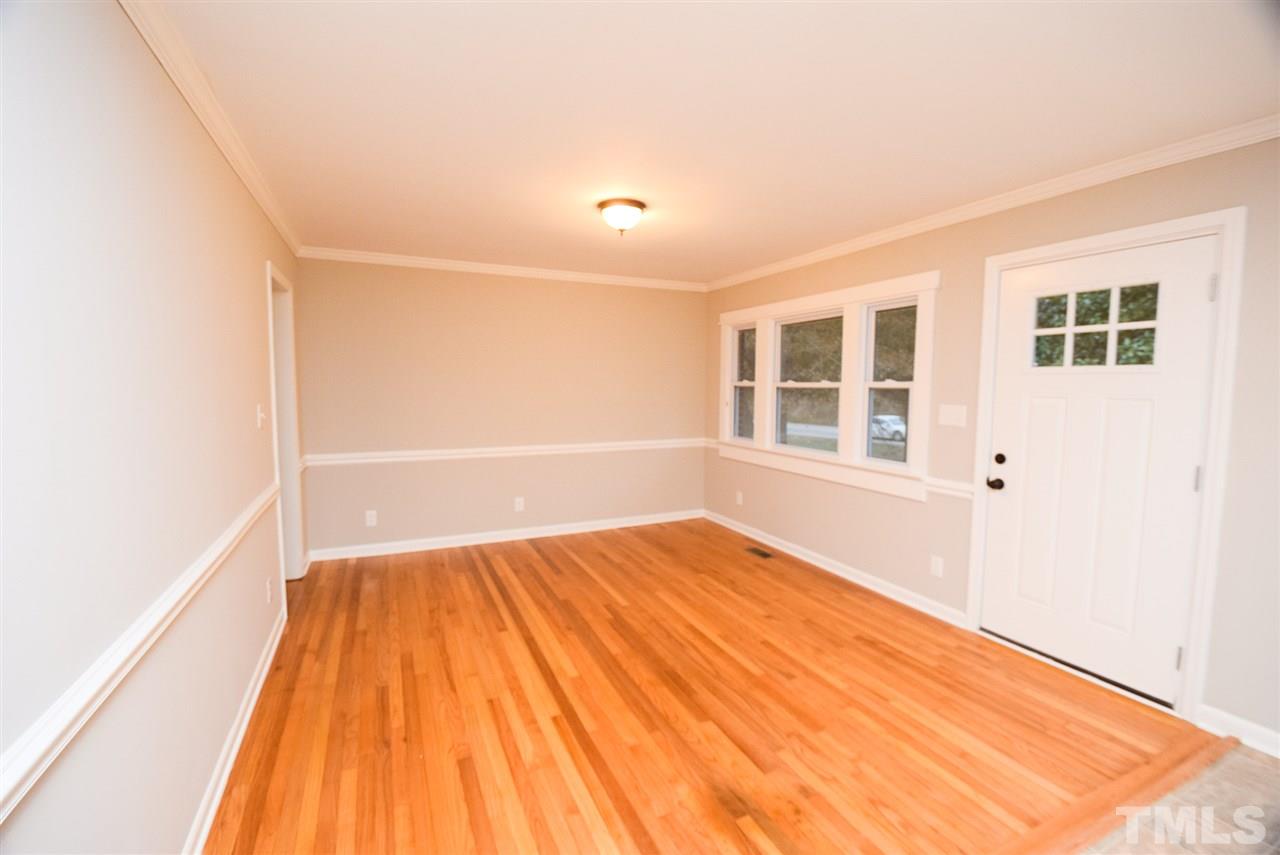 5300 Rock Quarry Road Raleigh, NC 27610 - Photo 8 of 19 a view of empty room with wooden floor and windows