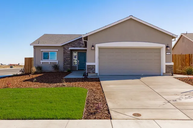a front view of house with yard and green space