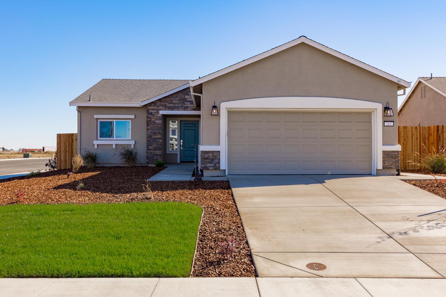 a front view of house with yard and green space
