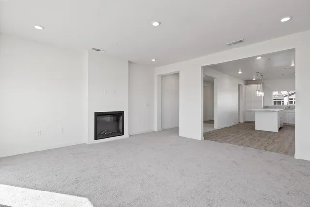 a view of an empty room with a fireplace