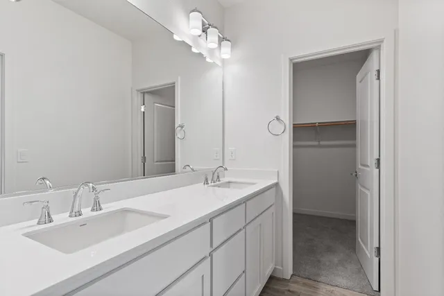 a bathroom with a double vanity sink and a mirror