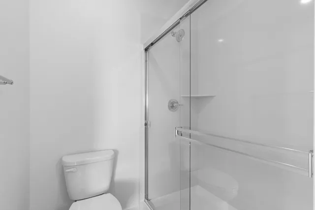 a bathroom with a toilet and shower