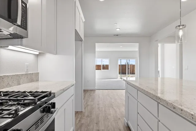 a kitchen with granite countertop a stove and a sink