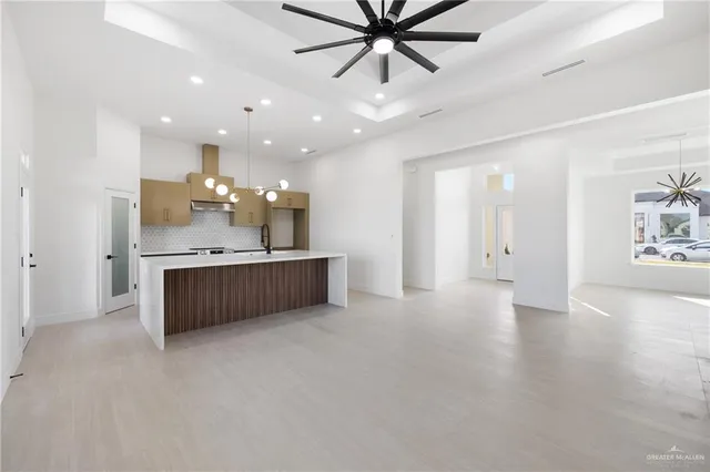 a large kitchen with a lot of cabinets and wooden floor