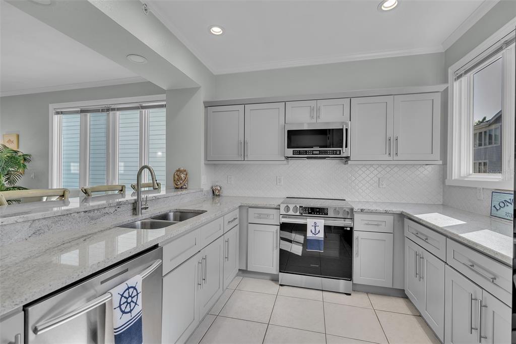 848 Evergreen Way Longboat Key, FL 34228 - Photo 8 of 66 a kitchen with a sink stove and cabinets