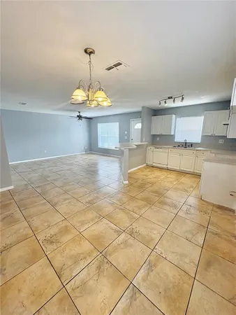 a view of a kitchen with a sink cabinets and a counter top space