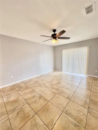 a view of an empty room and a window
