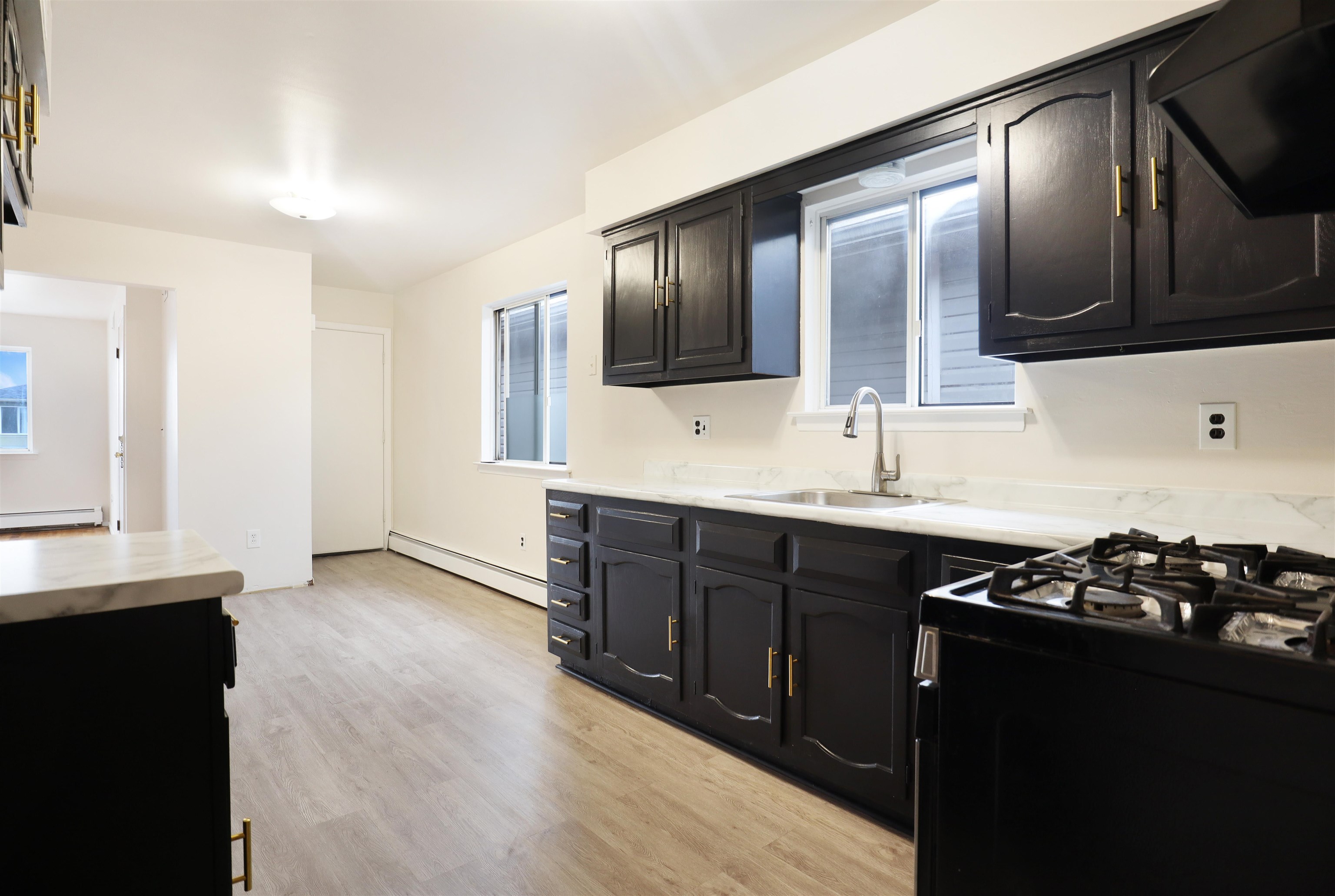 711 Bergen Street, Unit 2 Harrison, NJ 07029 - Photo 8 of 13 a kitchen with stainless steel appliances granite countertop a stove a sink and a microwave