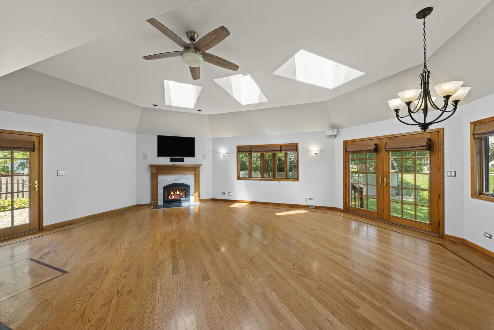 2114 Countryside Circle Naperville, IL 60565 - Photo 11 of 29 a view of an empty room with a window and wooden floor
