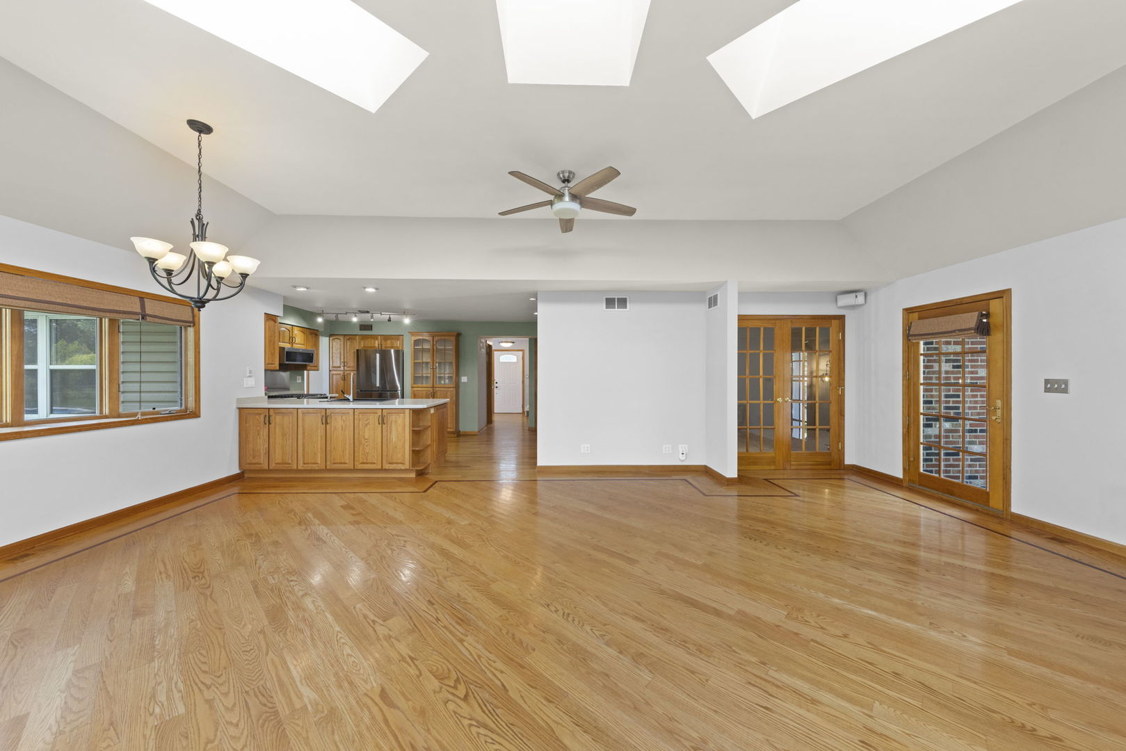2114 Countryside Circle Naperville, IL 60565 - Photo 12 of 29 a view of an empty room with window and wooden floor